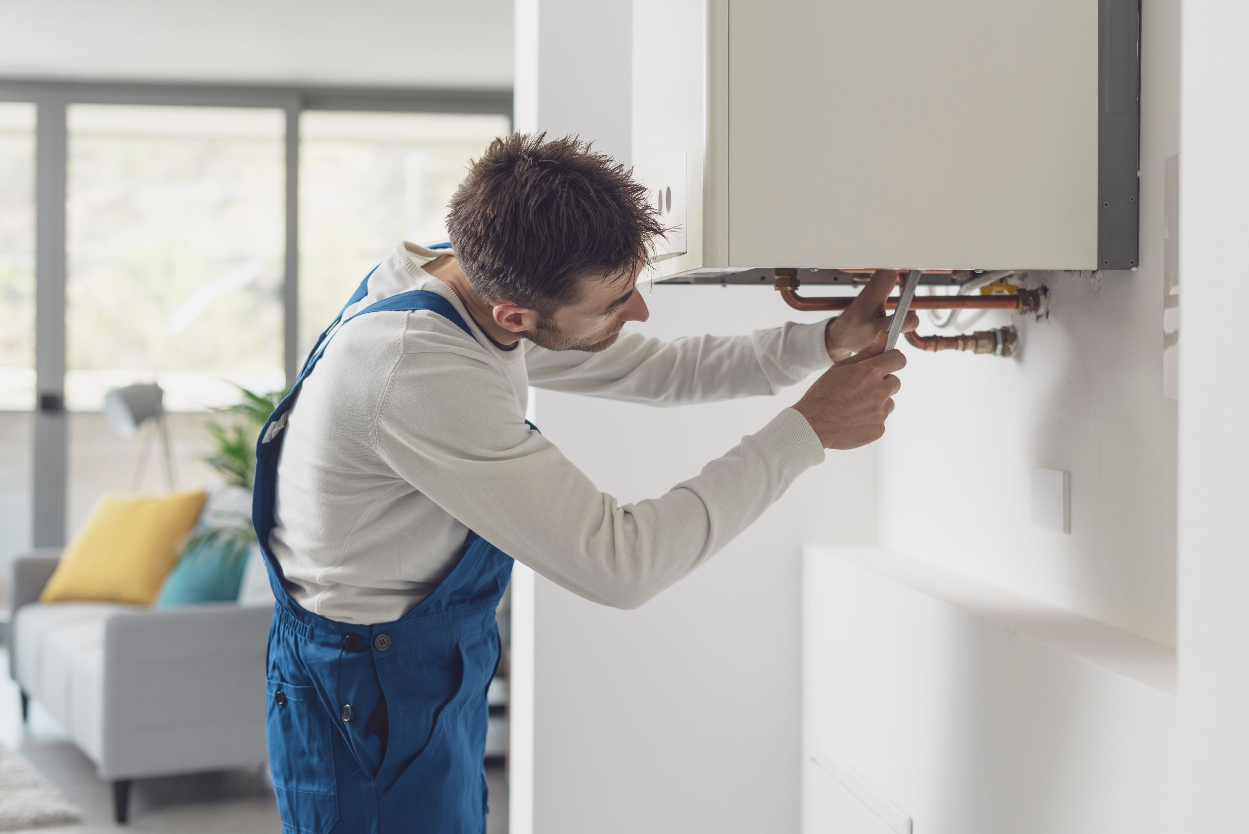 man repairing a boiler