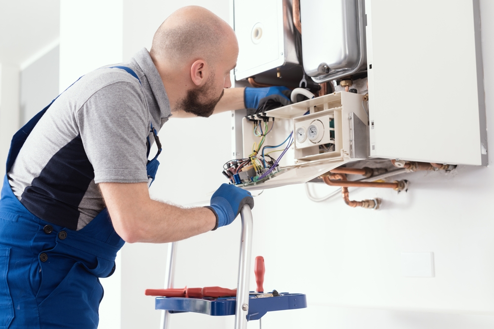 engineer servicing a boiler