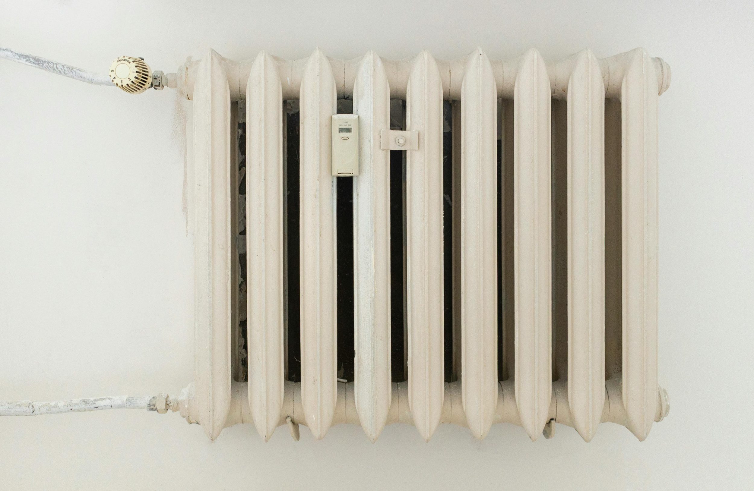Thermostat attached to the outside of a radiator.