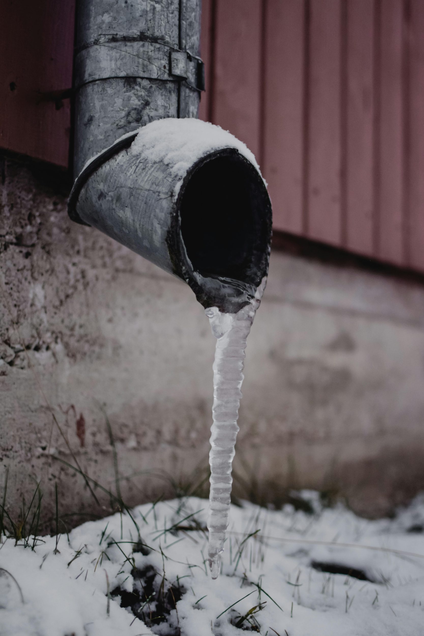 Outside pipe with frozen water dripping out.